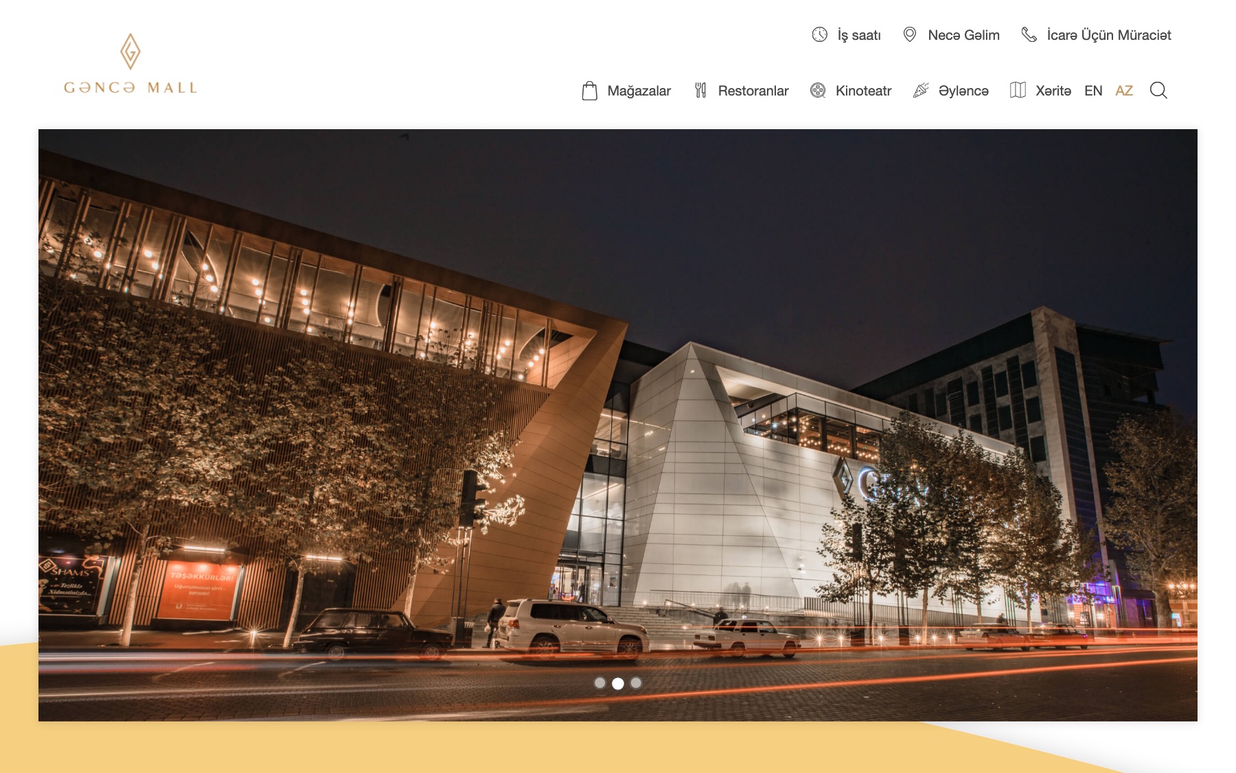 the ganja mall home page, a photo of the mall at night under a navigation bar for stores, restaurants, cinema, entertainment and the map